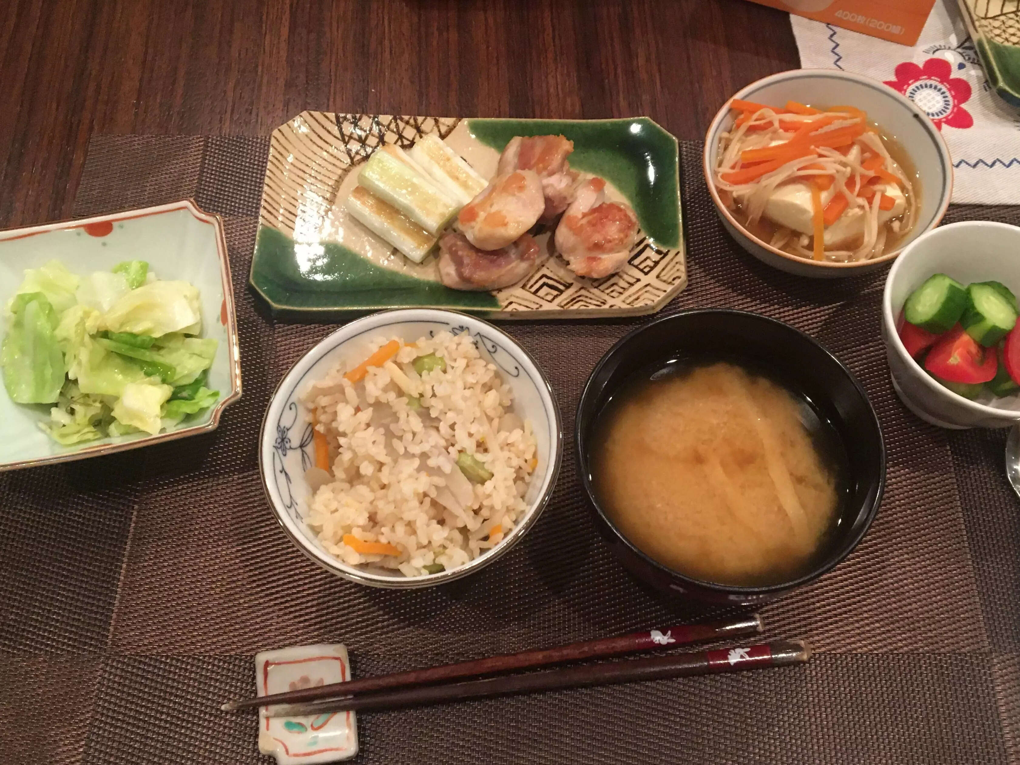A Japanese meal with six different dishes including rice and vegetables.