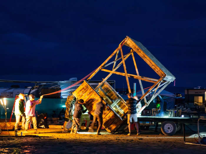 Burners work together to load a structure onto a flatbed truck