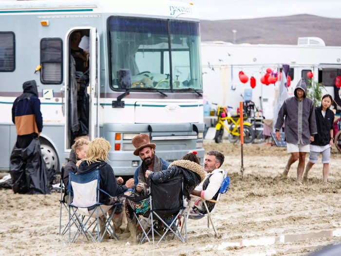 Burners set up chairs in the street between storms. Some used trashbags to walk through the mud while others walked barefoot.