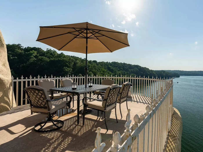 The balcony on the side of the home offers panoramic views across the lake.