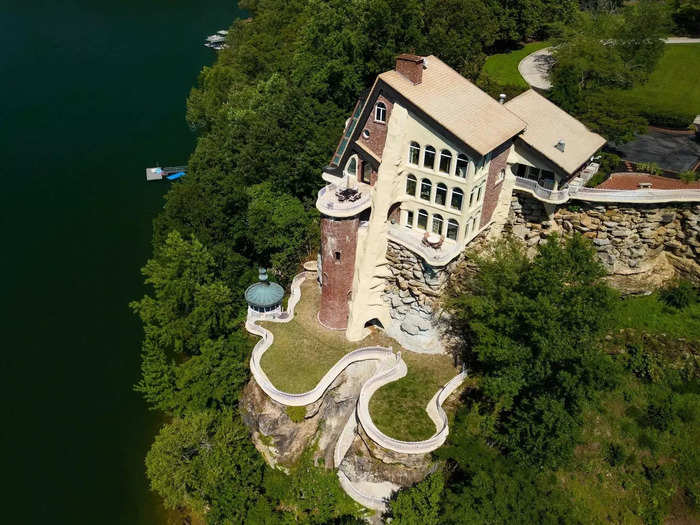 The house combines several architectural styles, featuring a turret, stonework, and an outside gazebo.