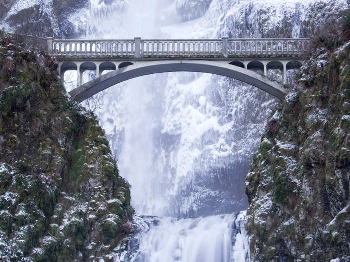 During the winter months, the snowy waterfall still flows, although it can partially freeze over.