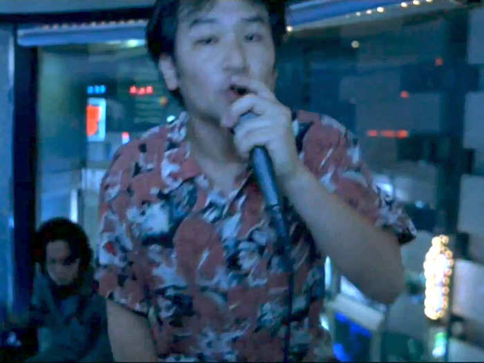 Fumihiro Hayashi gives a memorable performance of "God Save the Queen" during the karaoke scene.
