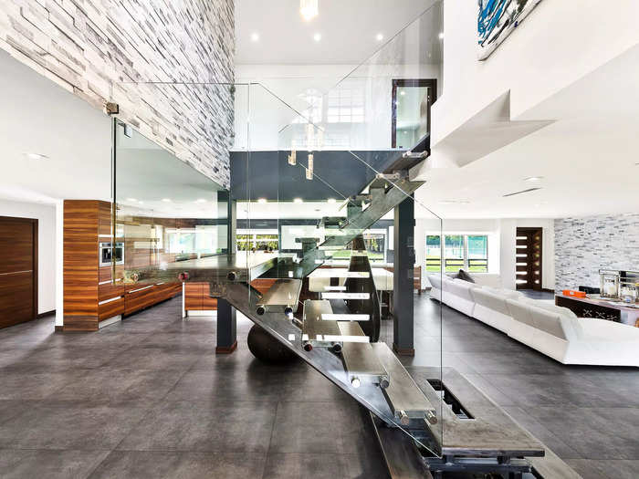 A floating glass staircase in the center of the home is one of its focal points.