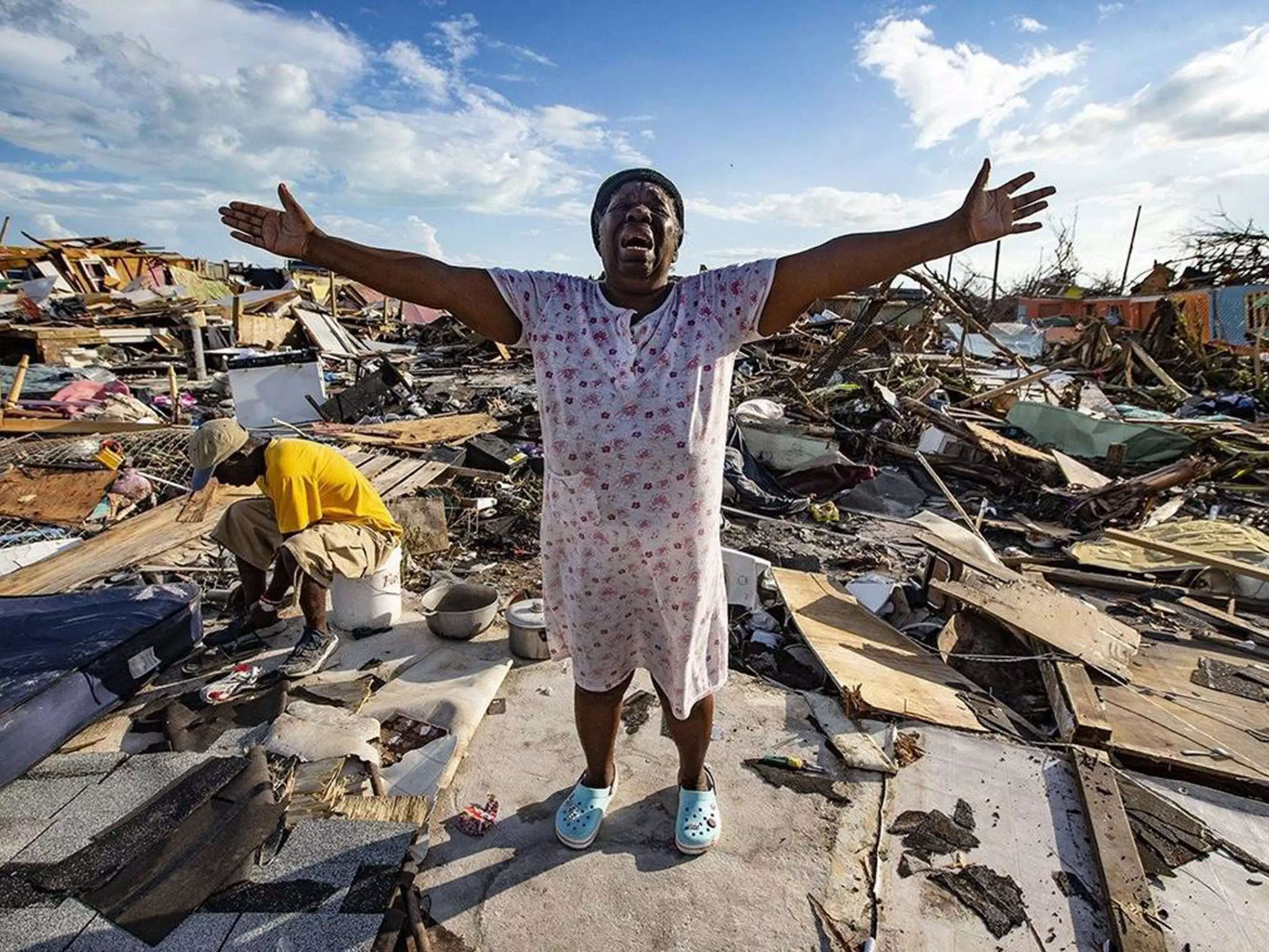 Aliana Alexis of Haiti stands on the concrete slab of what is left of her home after destruction from Hurricane Dorian in Great Abaco Island, Bahamas on Sept. 5, 2019.