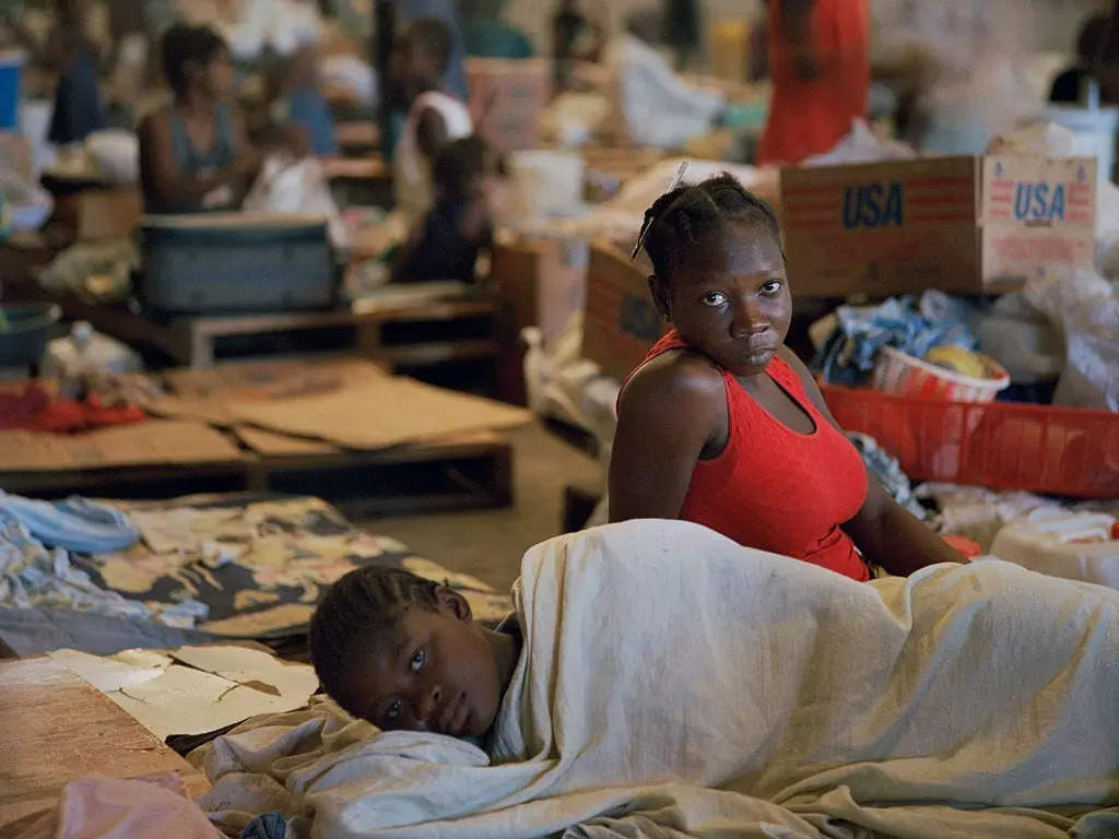 Displaced people stay in a warehouse in Haiti after losing their homes to flooding due to Hurricanes Ike and Hanna in 2008. The country was subjected to four powerful hurricanes and tropical storms within only 20 days.