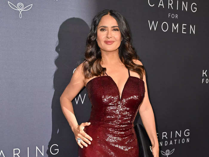 Salma Hayek wore a sparkly Gucci dress in burgundy. The neckline of the form-fitting dress dipped low, and it had a slit on one side.