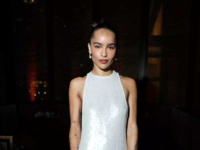 Zoë Kravitz arrived at the event in a silver dress with a high neckline that cut low on the sides.