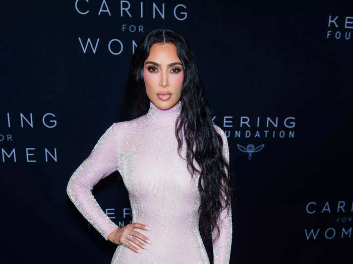 Kim Kardashian wore a sheer gown with a high neckline, long sleeves, and a train. Sparkles covered the Balenciaga dress.