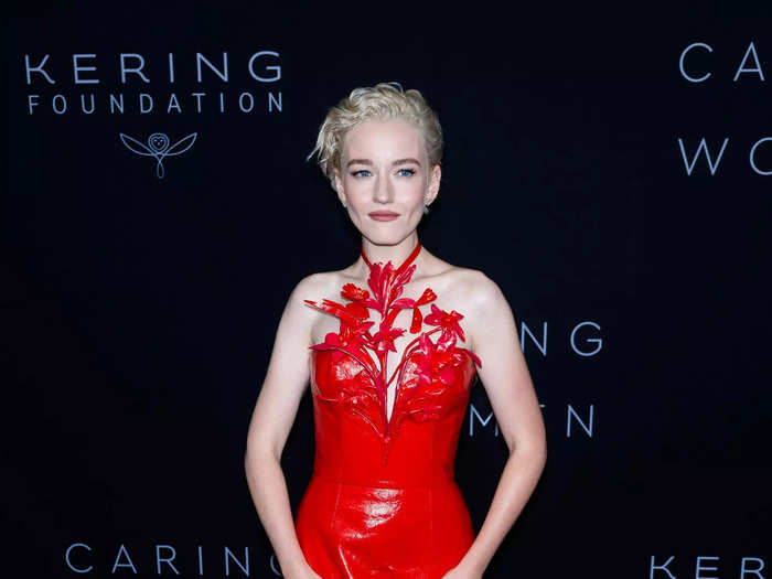 Floral embellishments created the halter neckline of Julia Garner