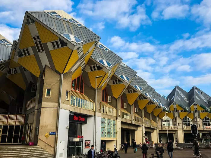 These yellow cubes perched atop these buildings are actually houses.