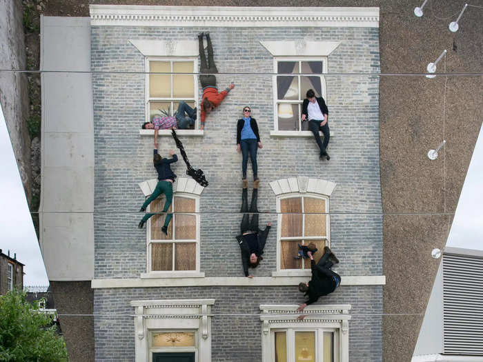 They were actually lying on the ground, and the "building" was a giant mirror.