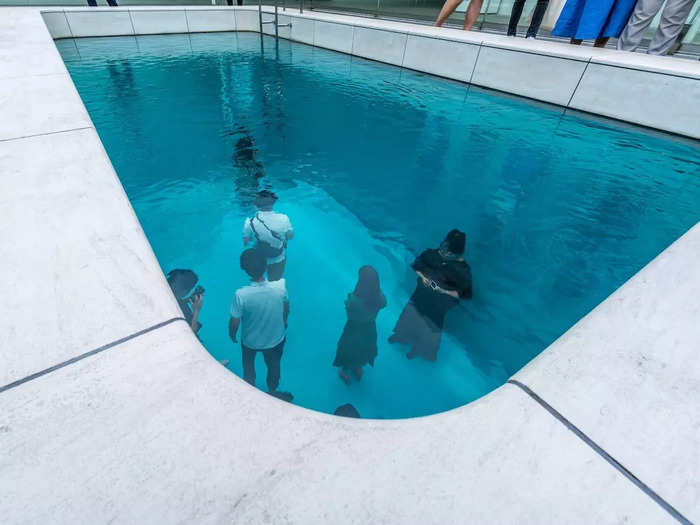 At first glance, you might think these people are standing at the bottom of an inground swimming pool.