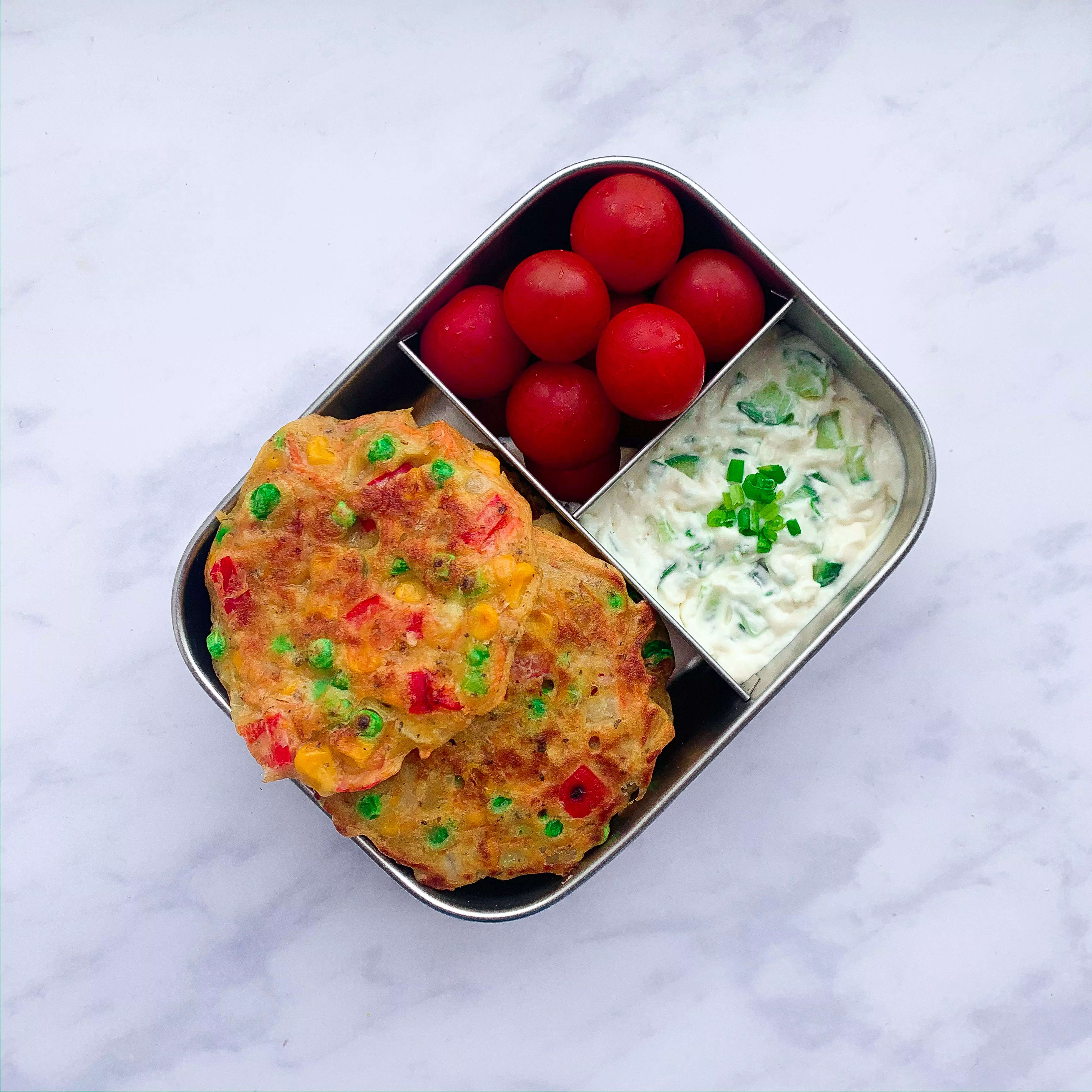 Veggie fritters with tomatoes and a tzatziki style dip