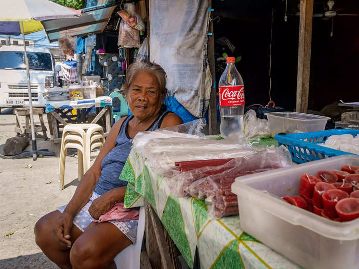 Virginia is one of the residents who sells candles to visitors for a living. She lives in a house covered in tombstones right outside the cemetery.