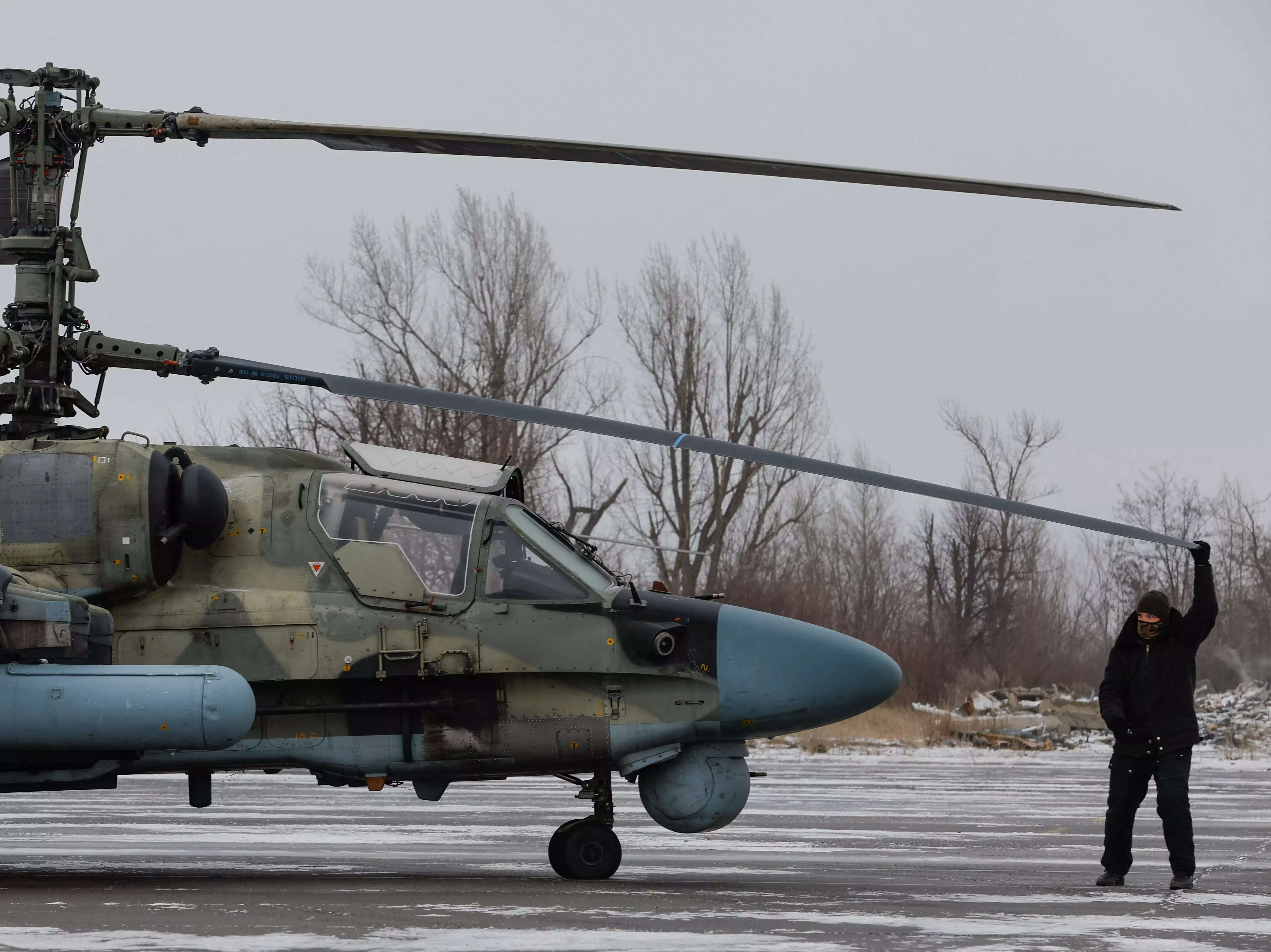 A serviceman checks a Russian Ka-52 "Alligator" attack helicopter in Luhansk.