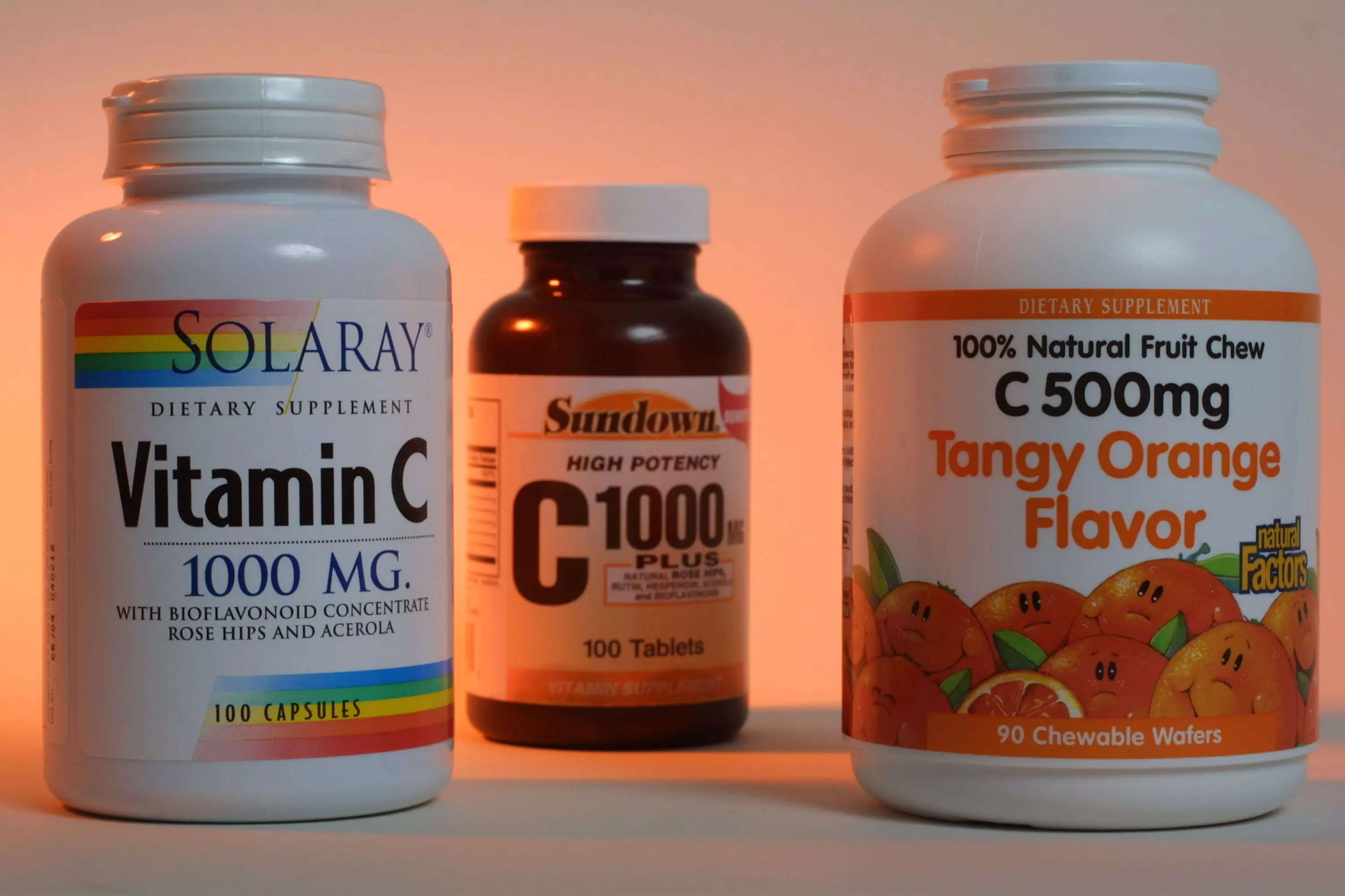 Three bottles of vitamin C supplements.