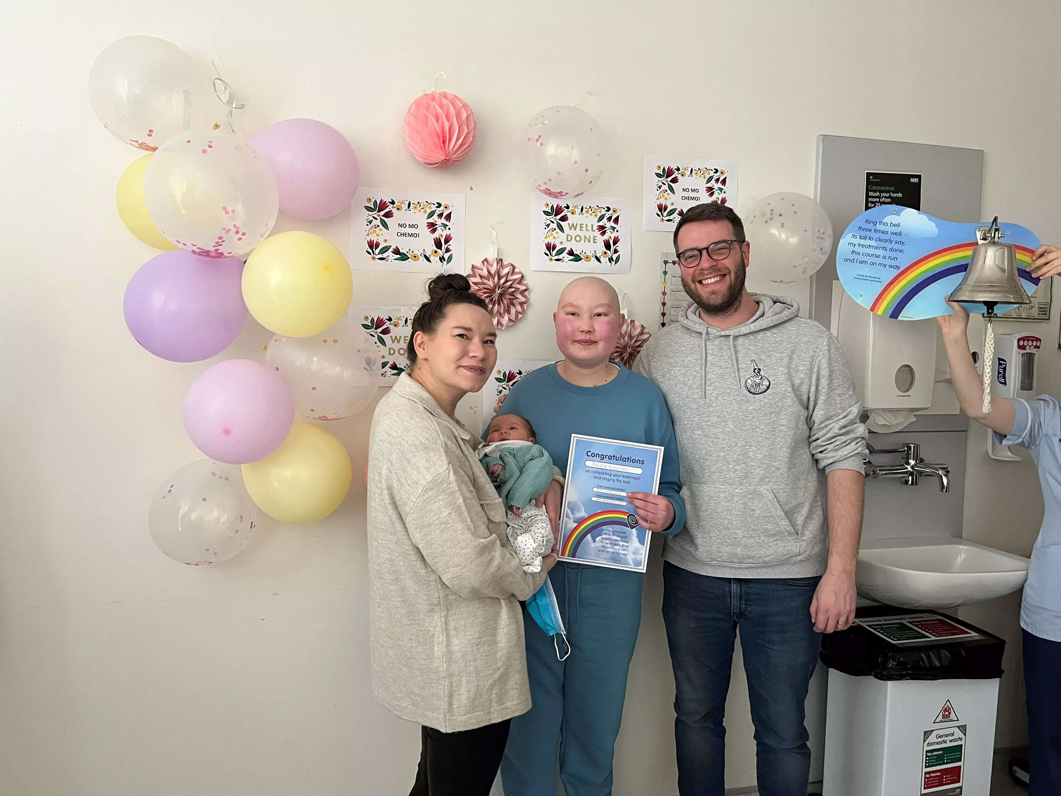 Phoebe Daniel with her family in a hospital room after she completed a chemotherapy treatment.