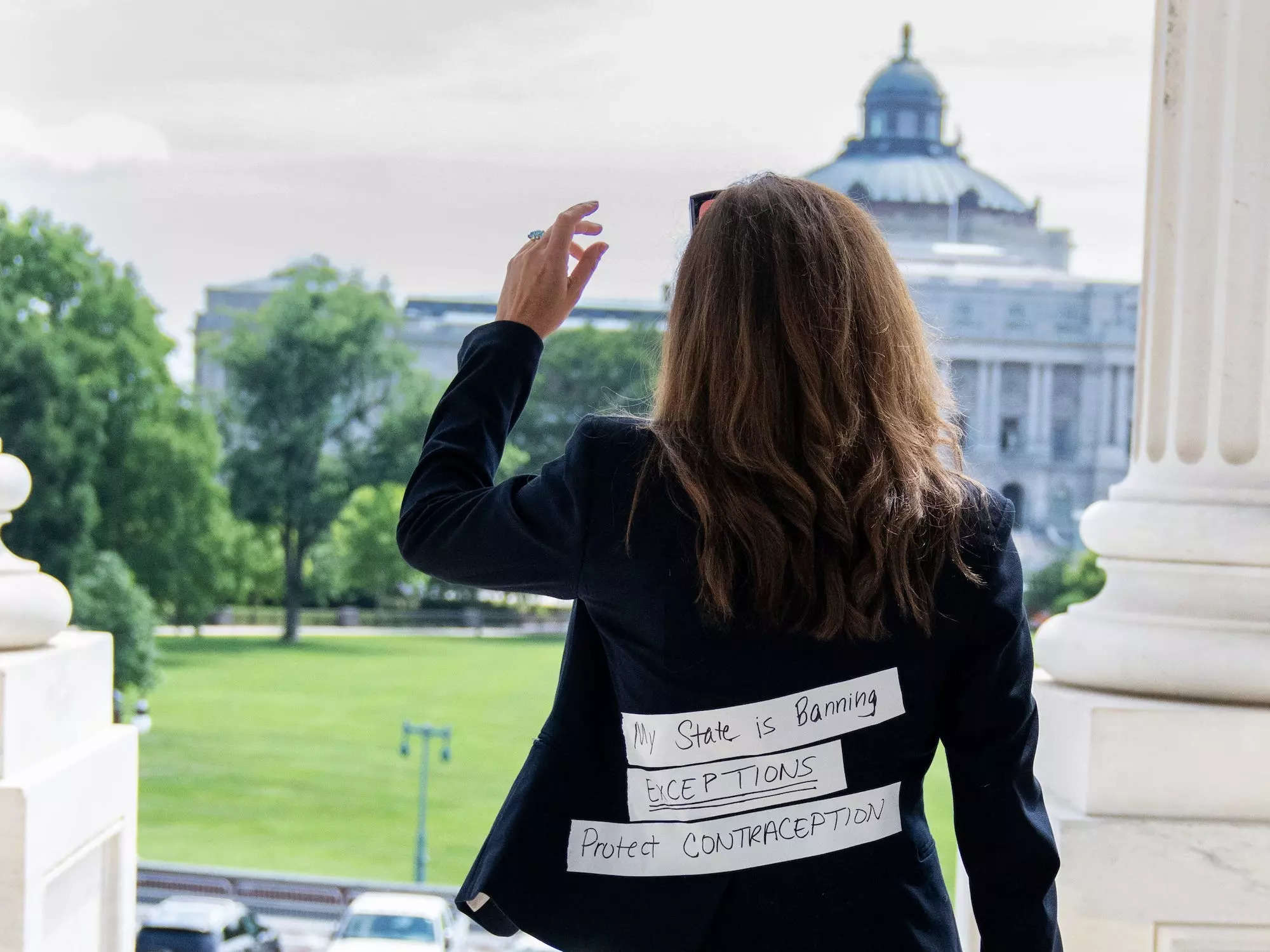 Mace wearing a jacket with a message on the back at the Capitol in July 2022.