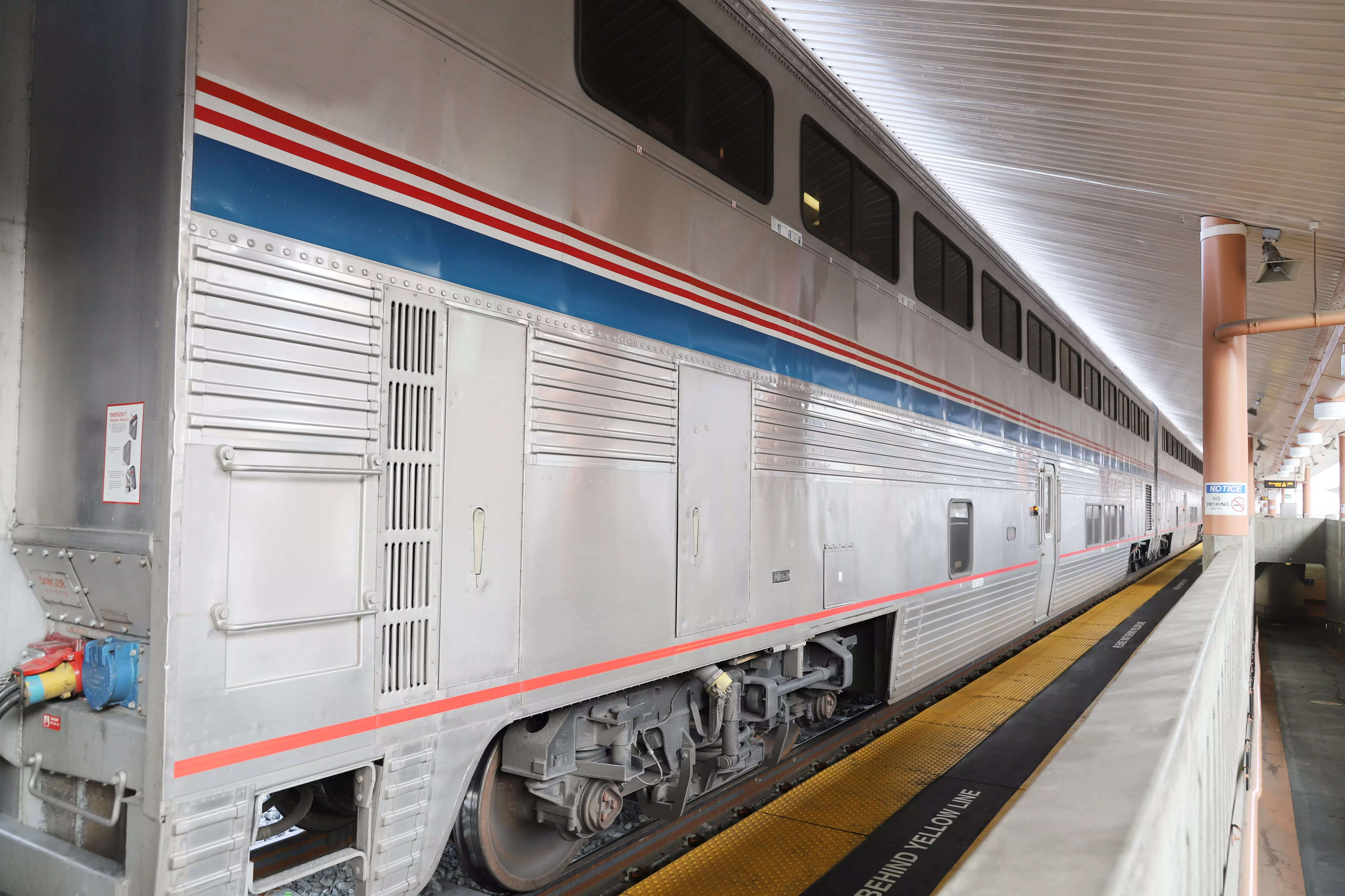 The exterior of an Amtrak train at a station.