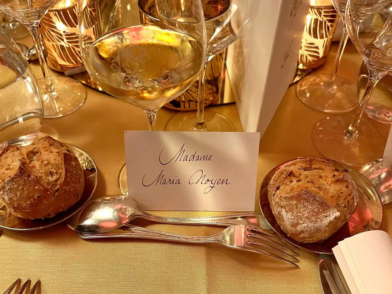 A handwritten place card designated the seating arrangements.