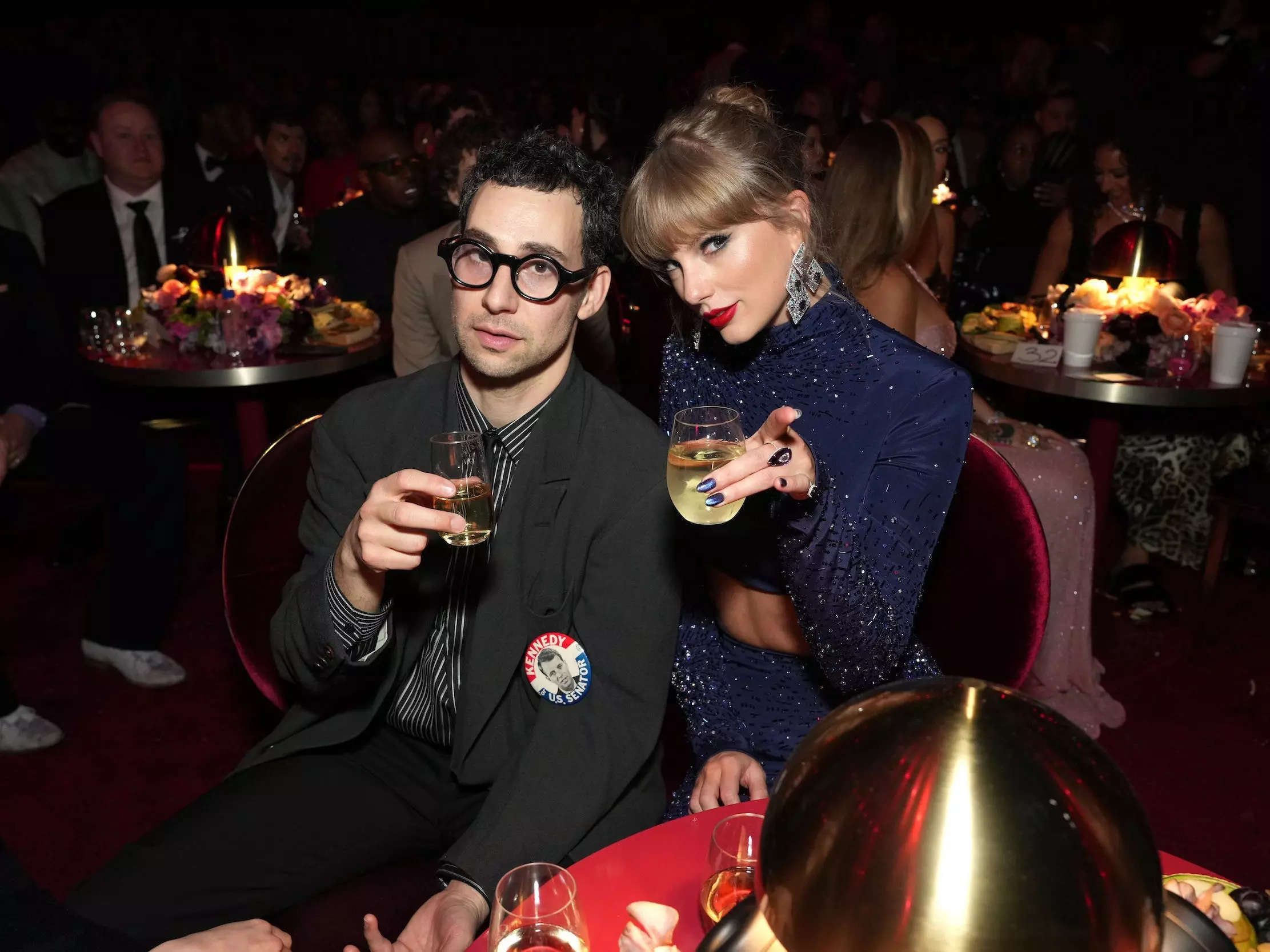 Taylor Swift (right) and longtime music collaborator Jack Antonoff toast to the camera during the 2023 Grammy Awards.