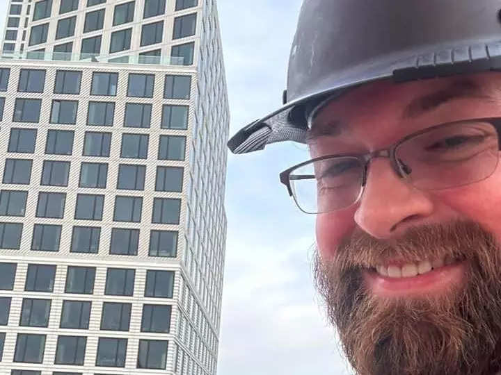 Crane operator Liam Tarrant outside a high-rise building