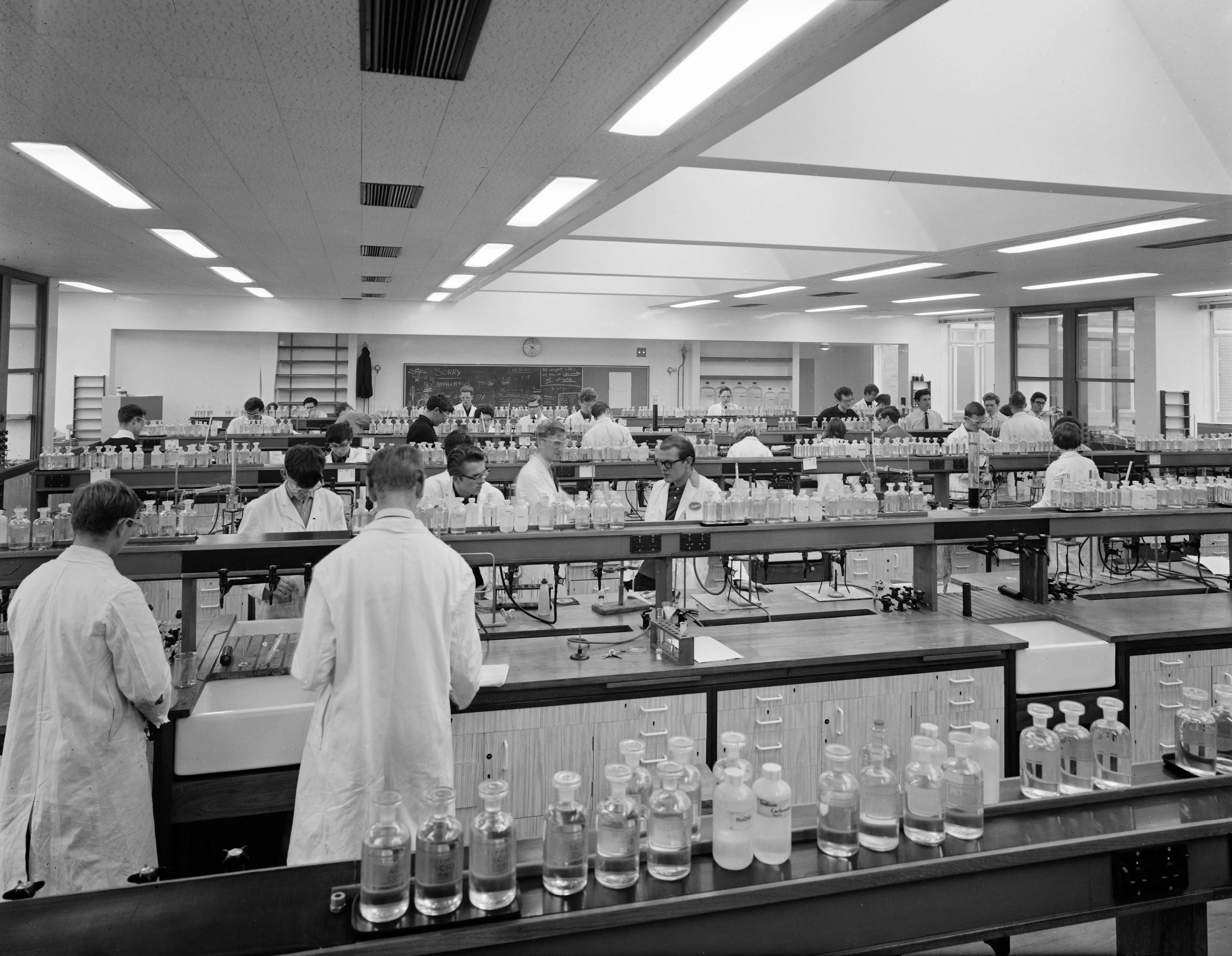 Men in white coats working in a lab
