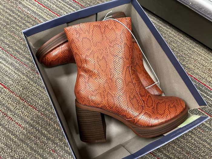 Next, I noticed brown snakeskin boots that resemble a designer pair.