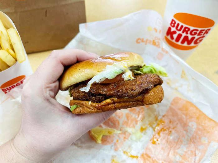 The chicken sandwich appeared to be coated in spicy flavoring. It also came topped with tomato, lettuce, and mayonnaise.