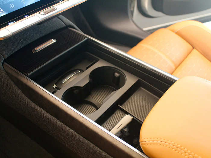 In the center console, cup holders can disappear beneath a leather platform. 