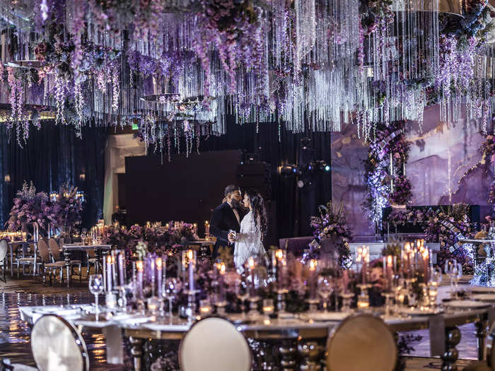 The vibe for the reception was celestial, like, "I love you to the moon and back." We had a celestial-themed custom dance floor, stars on the ceiling, and lighting in blue, purple, and red hues.