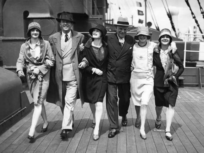 Cruise-ship passengers dressed in tailored suits and spiffy hats.