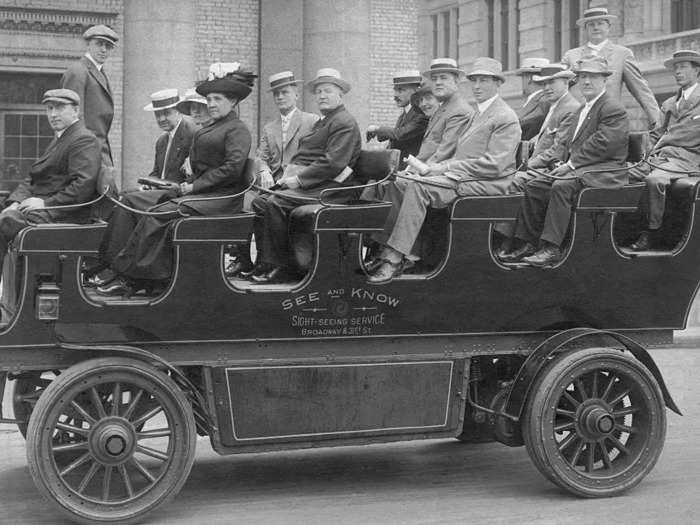 Tourists dressed up to ride sightseeing buses, which were then small electric vehicles.