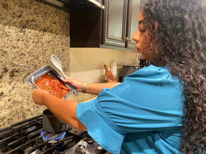 Then I heat the stew in a medium-sized pot over medium heat on the stove, stirring every so often for the next five or six minutes. I turn off the heat when the stew begins to boil.