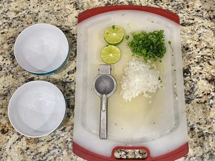 I chop half of the white onion and the whole package of cilantro. I also slice the lime to eventually squeeze on top.