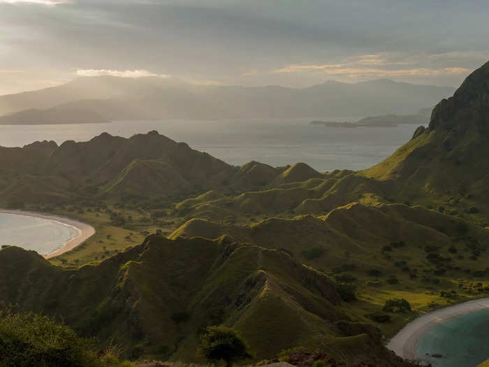 The landscape of volcanic mountains and long grasses is reminiscent of Jurassic Park, or Kong Island.