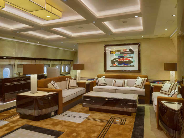 The centerpiece of the jet is the salon on the main floor with three couches, a coffee table, and vaulted ceilings.