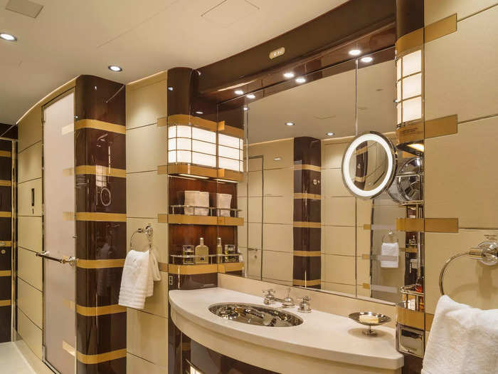 The master bathroom features a walk-in shower as well as a single vanity complete with a full mirror and sink.