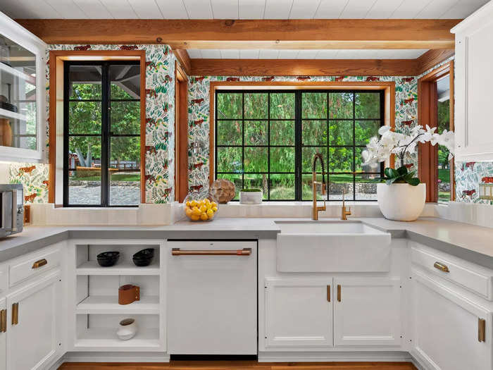 The kitchen features wallpaper with a horse motif that can be found throughout the house.