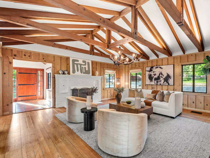 Exposed ceilings with wood beams, walls with wood panels, and hardwood floors, cover much of the home.