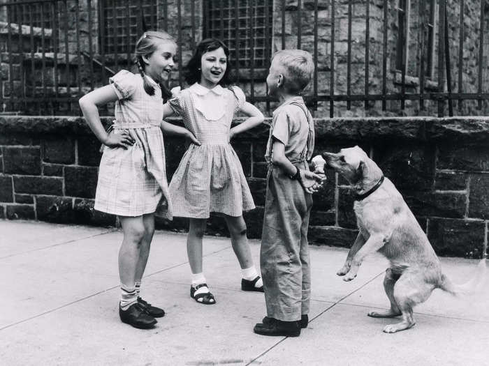 A boy is a little too focused on flirting — he should be watching his ice cream.