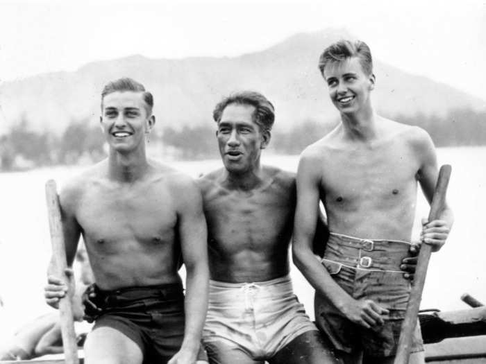 August 1934: Former first sons Franklin Roosevelt Jr., left, and John Roosevelt, right, pose with surfer Duke Kahanamoku in Waikiki, Hawaii.