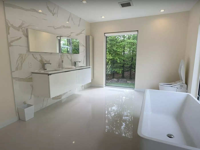 And a massive bathroom complete with a double vanity, soaking tub, and shower.