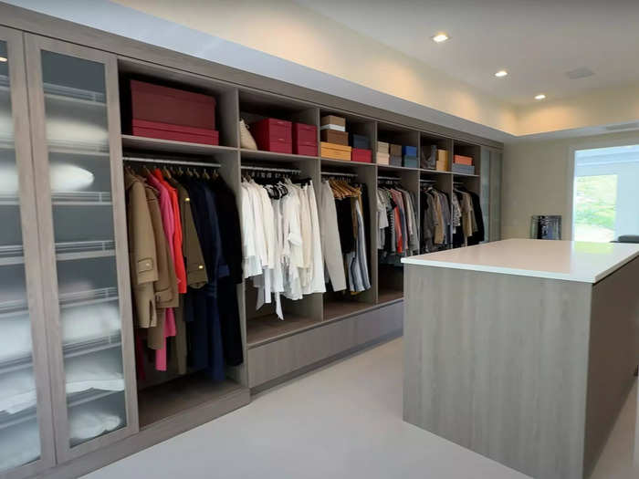 The walk-in closet, nestled between the bed and the bathroom area, is a shopper