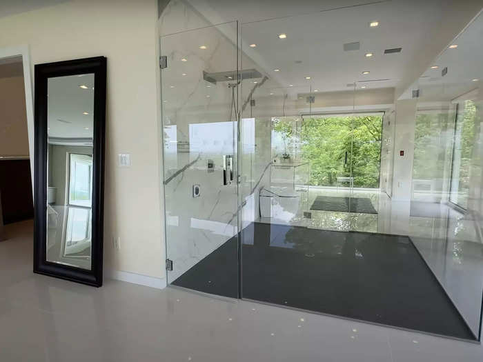 As is the massive shower, which includes a rain shower head as well as a handheld shower head and steam shower accessories encased in a glass cube.