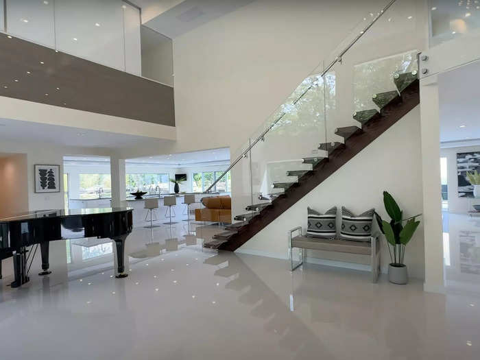 The airy foyer comes complete with a floating staircase and an overlook from the second floor.