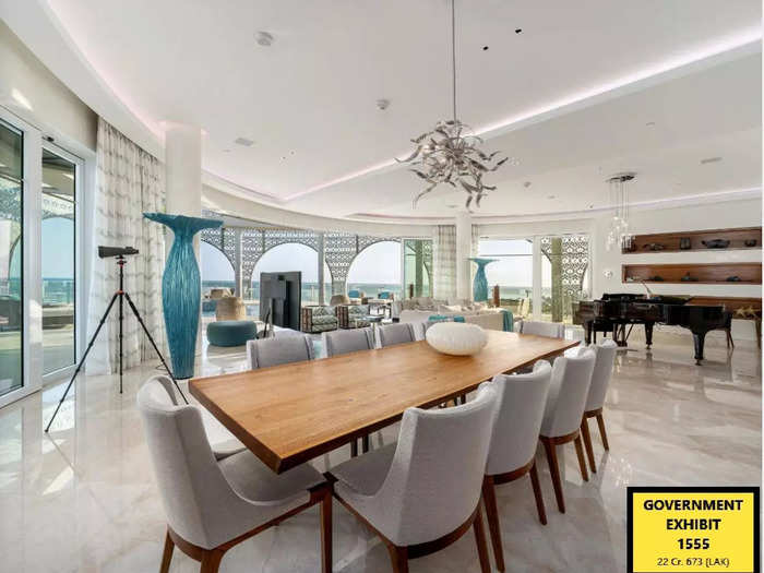 The living room and dining area overlook an outdoor pool and jacuzzi.