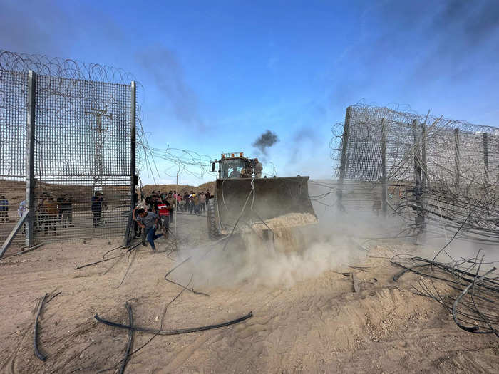 7. Palestinians break into the Israeli side of Israel-Gaza border fence in a bulldozer.