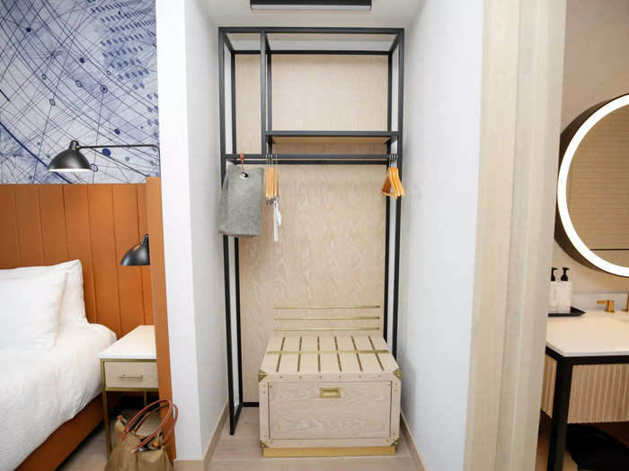 Across from the entry door and industrial chic coat hooks, a clothing rack with shelves took the place of a traditional closet.